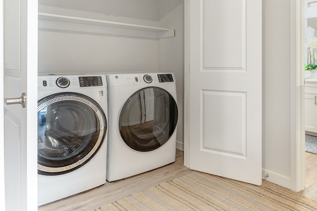 Two front load washing machines in a laundry room.