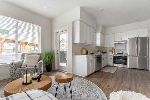 A modern kitchen with white cabinets and stainless steel appliances.