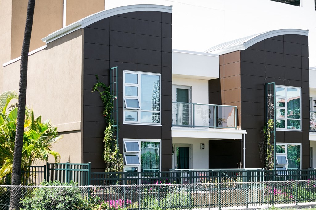 a house with a black and white facade and a balcony