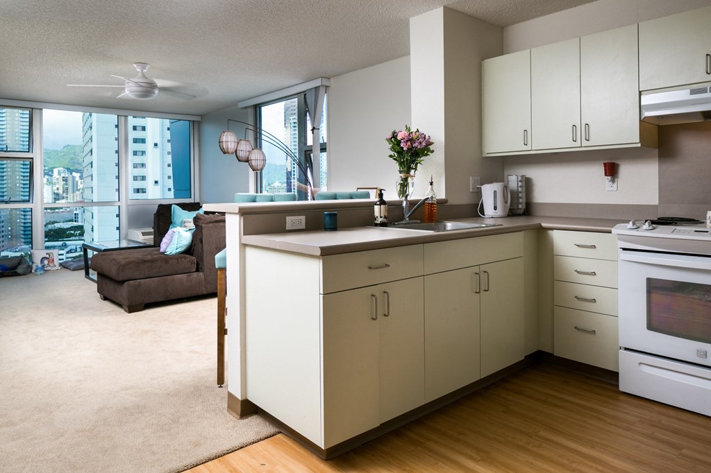 an open kitchen and living room with a view of the city