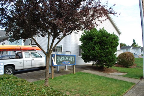 a white van parked in front of a house with a sign