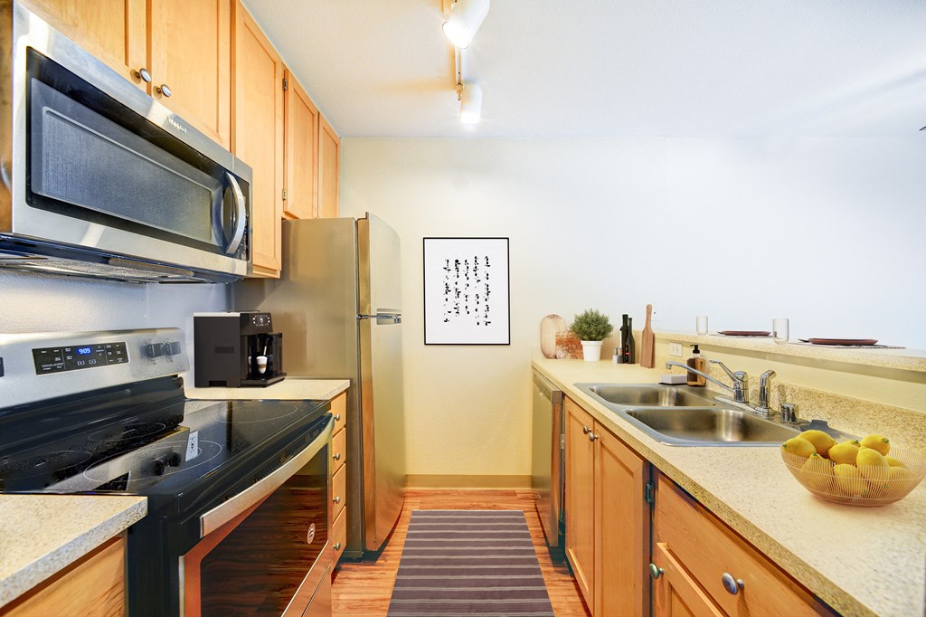 a kitchen with stainless steel appliances and wooden cabinets
