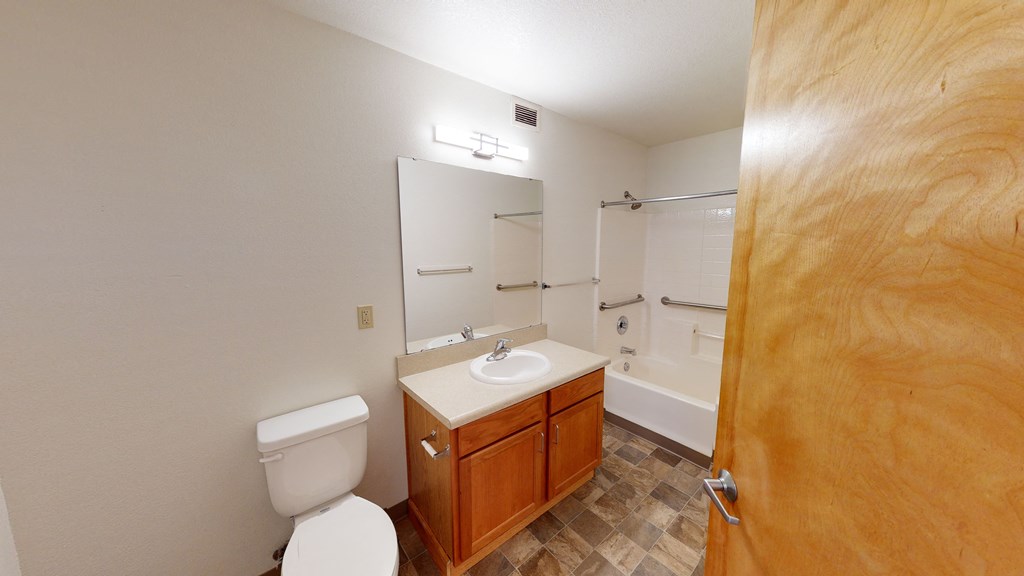 a bathroom with a toilet and a sink and a shower