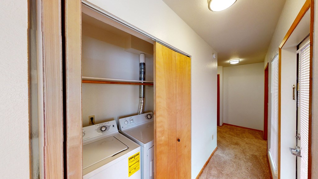 a washer and dryer in a laundry room with a door