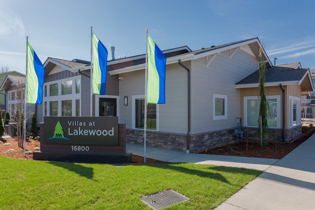 the village at lakewood exterior with flags in front of building
