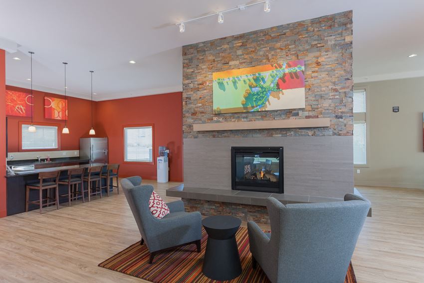 a living room with a fireplace and a table and chairs