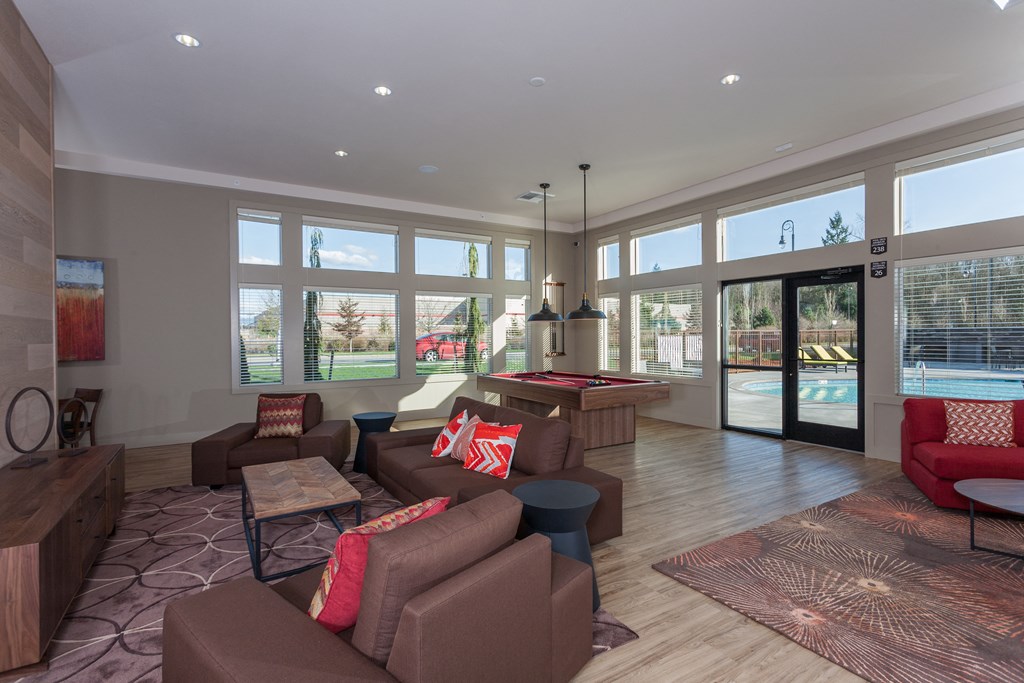 a large living room with couches and a pool table