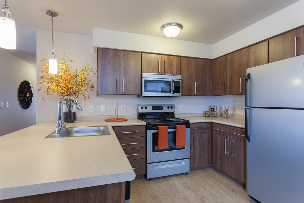 a kitchen with stainless steel appliances and white counter tops