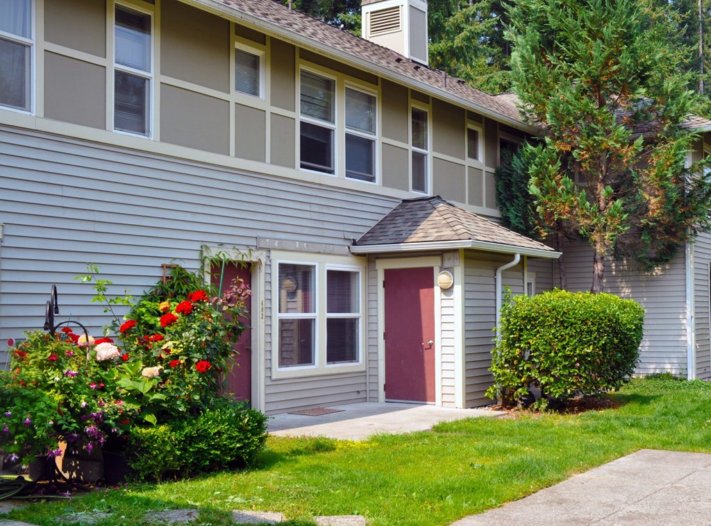 A house with a red door and a small porch.
