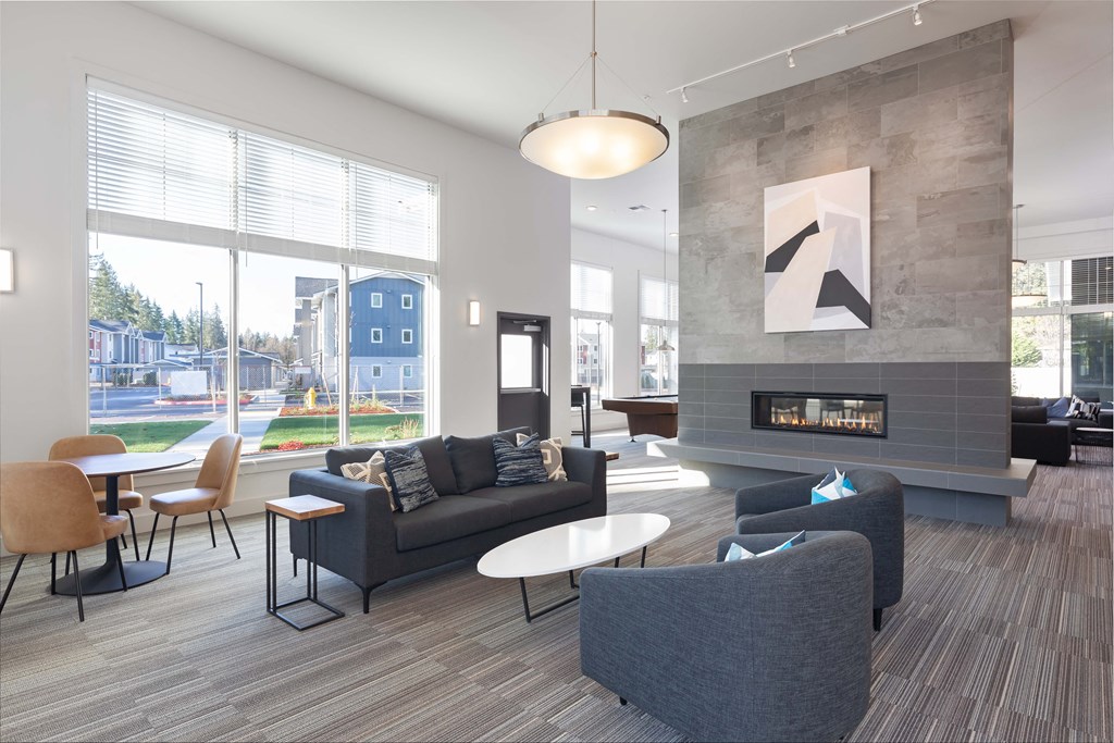 a living room with couches and chairs and a fireplace