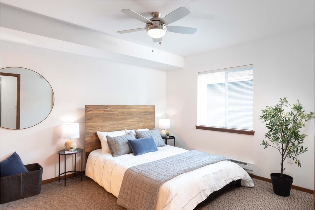 a bedroom with a bed and a ceiling fan