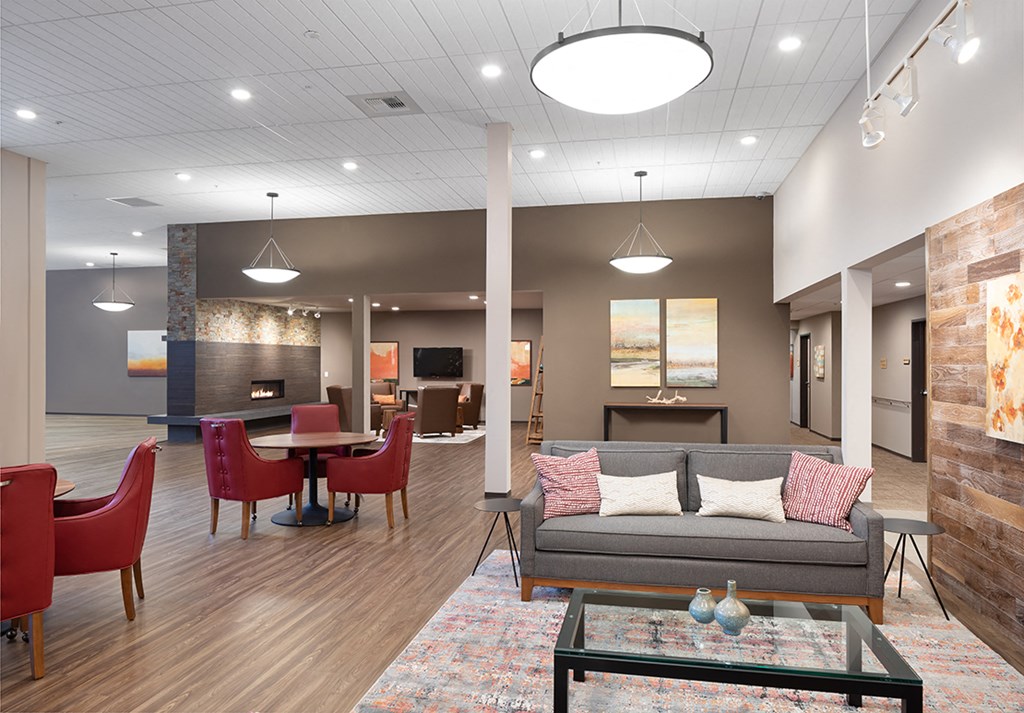 a living room and dining room with a couch and chairs