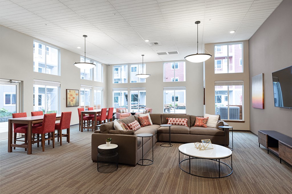 a living room with a couch and a table and chairs