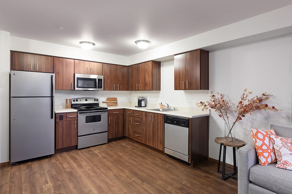 a kitchen with stainless steel appliances and wooden cabinets
