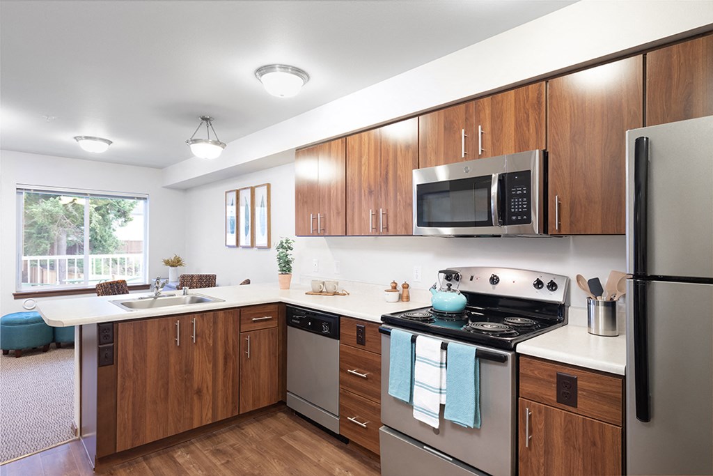 a kitchen with stainless steel appliances and wooden cabinets