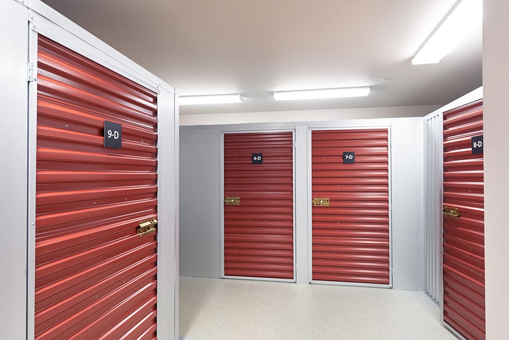 a row of elevators in a building with red doors