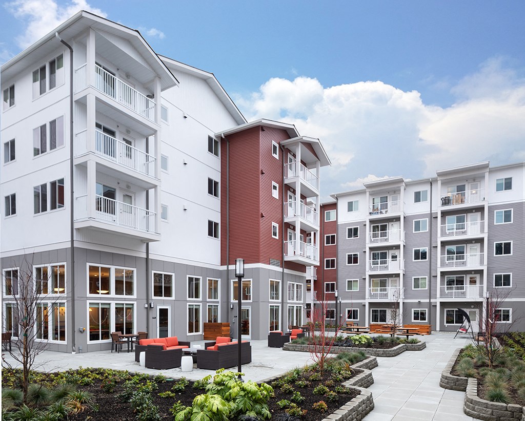 a group of modern apartment buildings with a courtyard