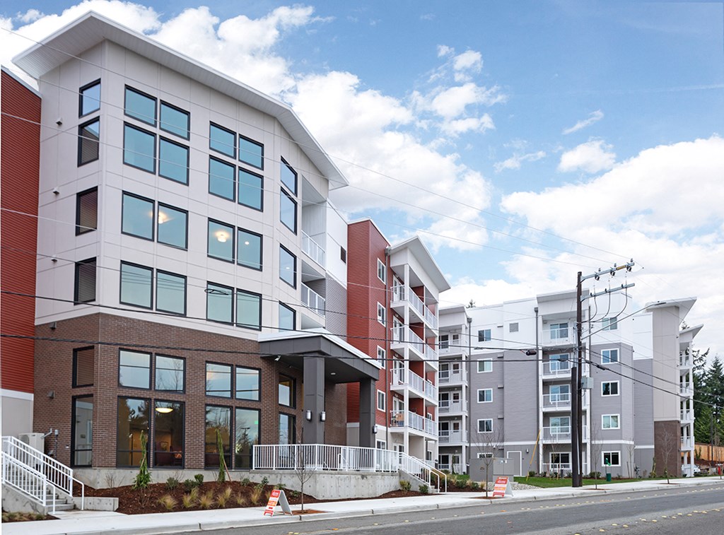 a group of new apartment buildings on a city street