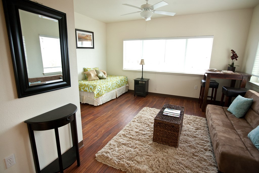an overview of a living room with a couch and a bed