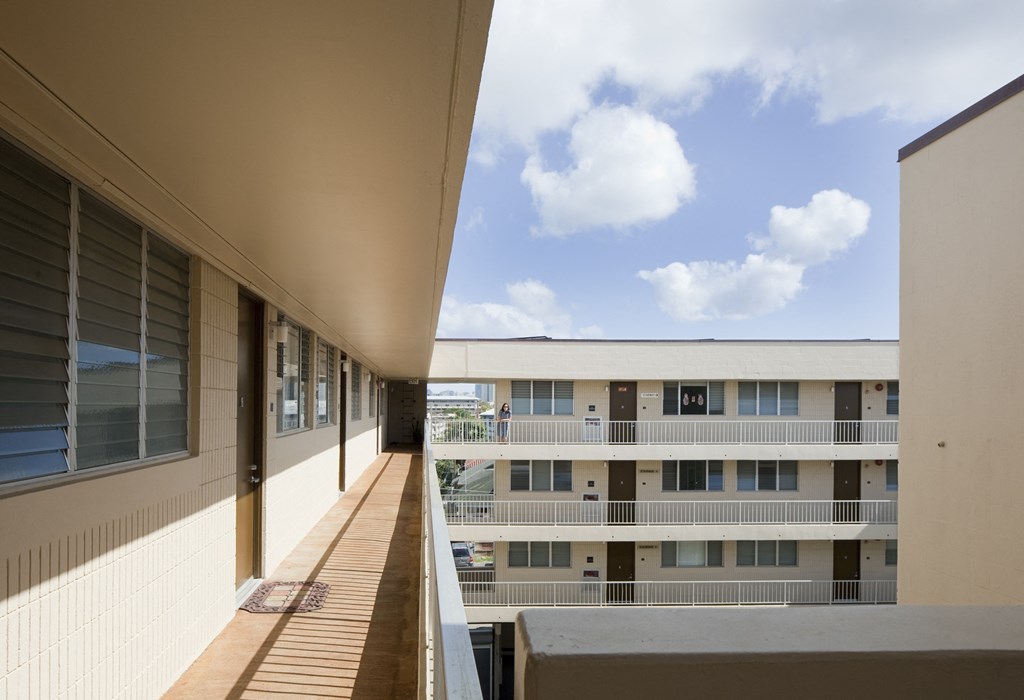 a view of a building from a balcony in a building with a blue sky