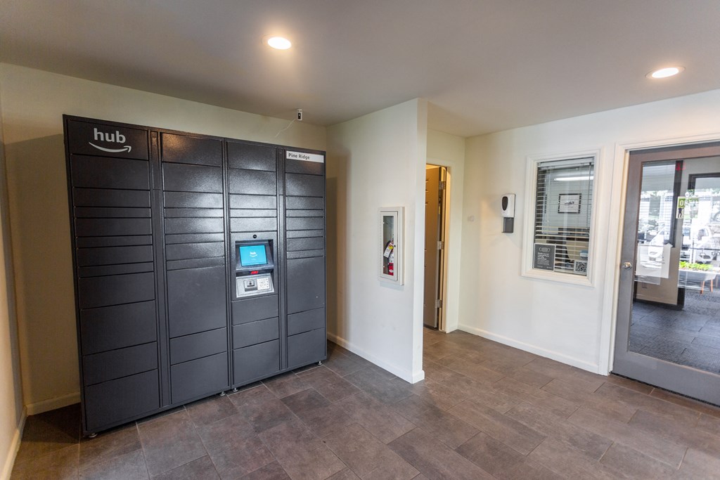 a lift lobby with a security door and a door to the lobby of a building