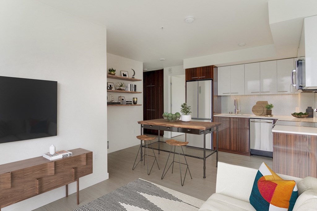 a living room and kitchen with a table and chairs and a television