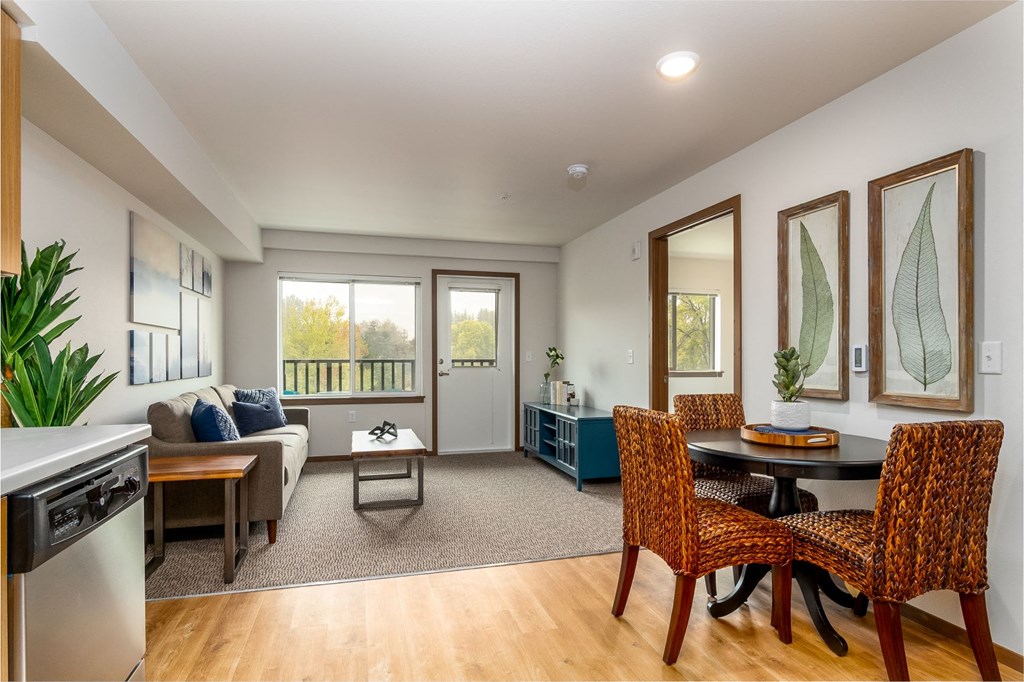 a living room with a couch and a table with chairs
