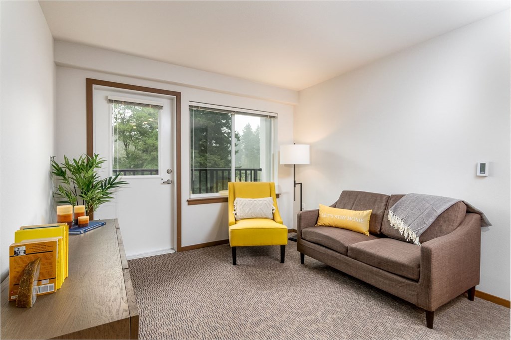 a living room with a couch and a yellow chair