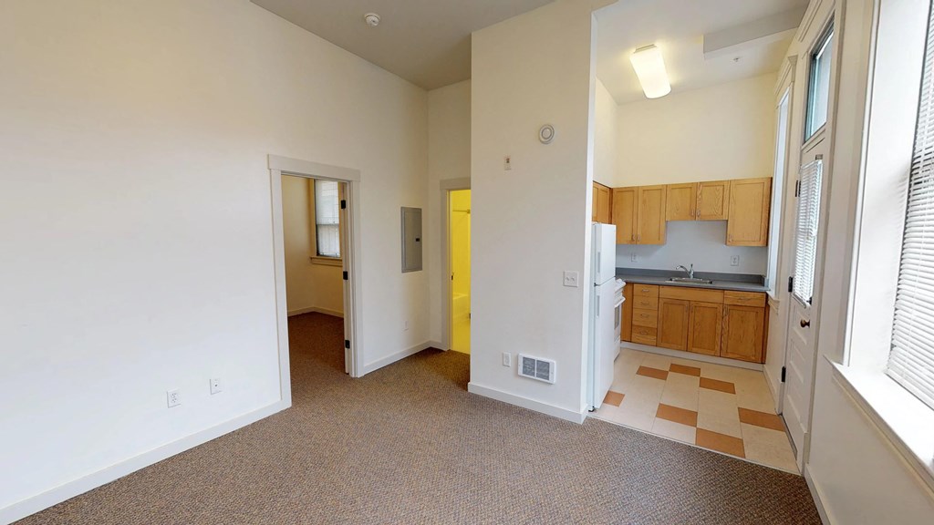 a view of a kitchen and a living room in an empty house