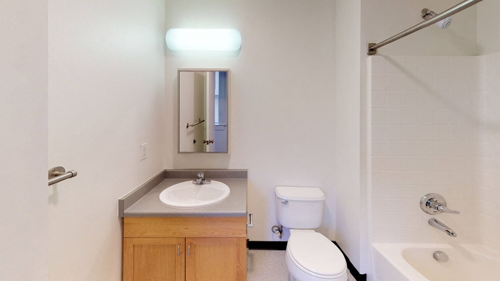 an empty bathroom with a sink toilet and shower