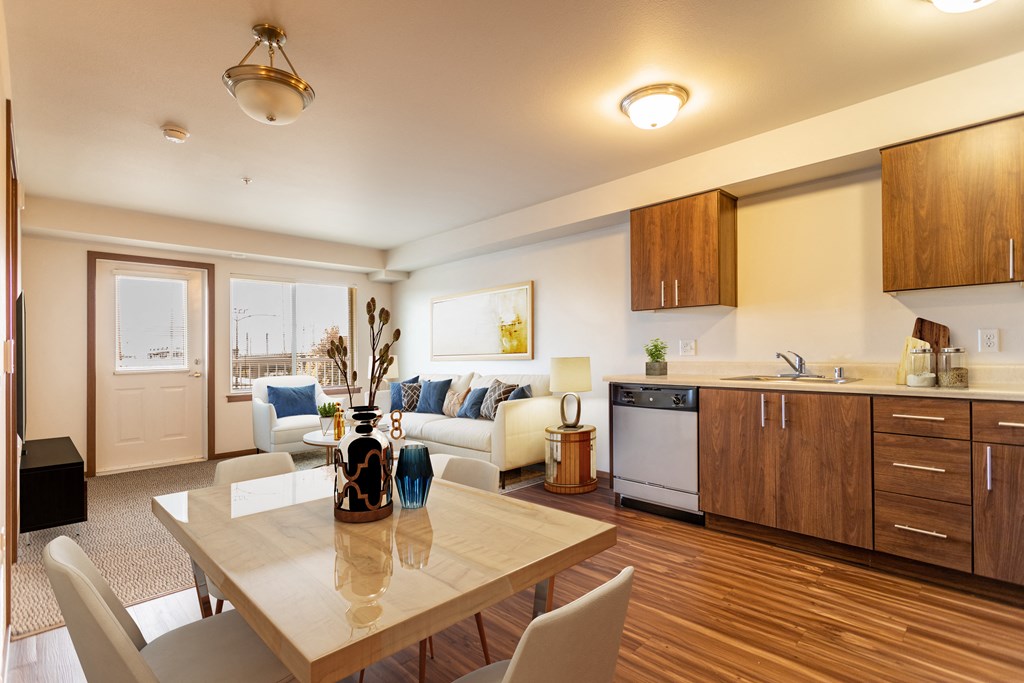 a living room with a kitchen and a dining table