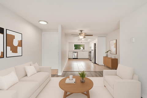 A living room with a white couch and a coffee table.
