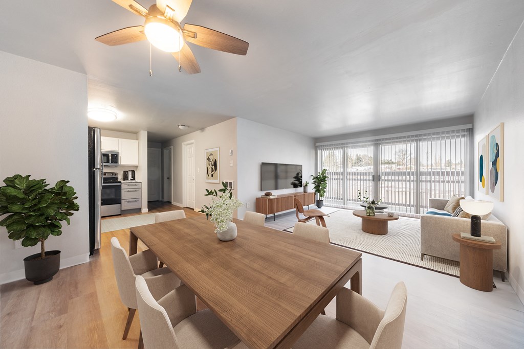 a living room and dining room with a wooden table