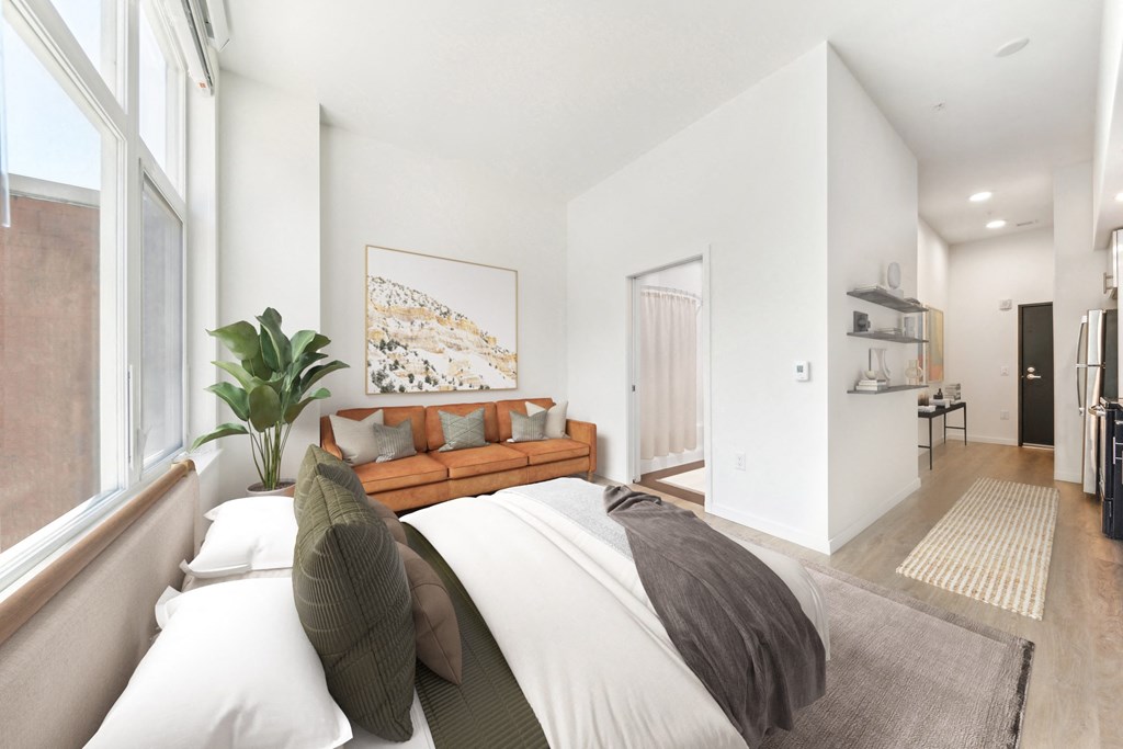 a bedroom with a large bed and a large window