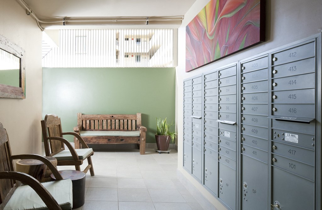 a locker room with a bench and chairs and filing cabinets