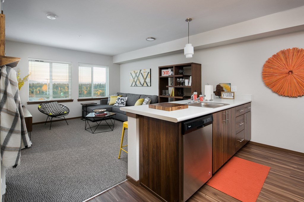 a living room with a kitchen and a couch and a table