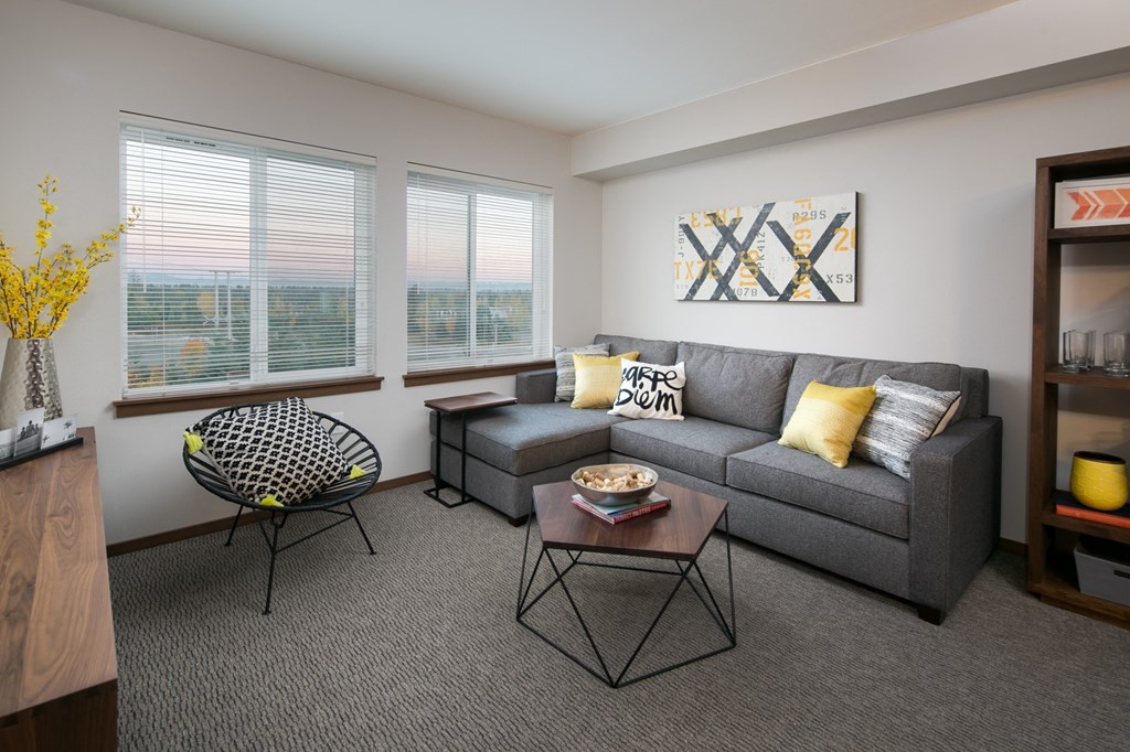 a living room with a gray couch and a coffee table