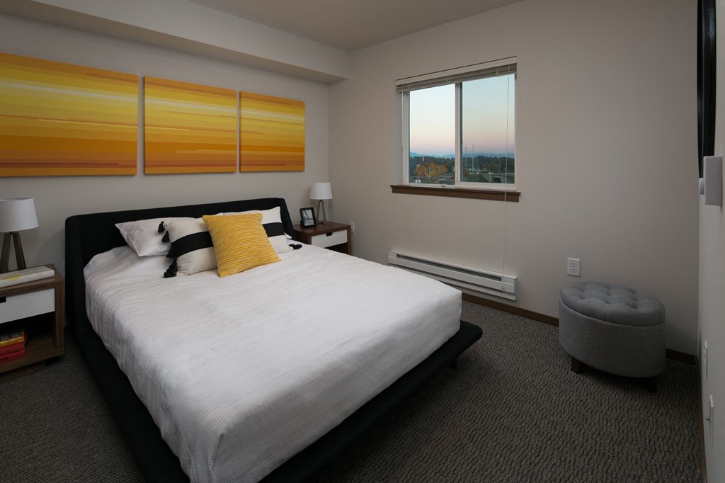 a bedroom with a large bed and a window