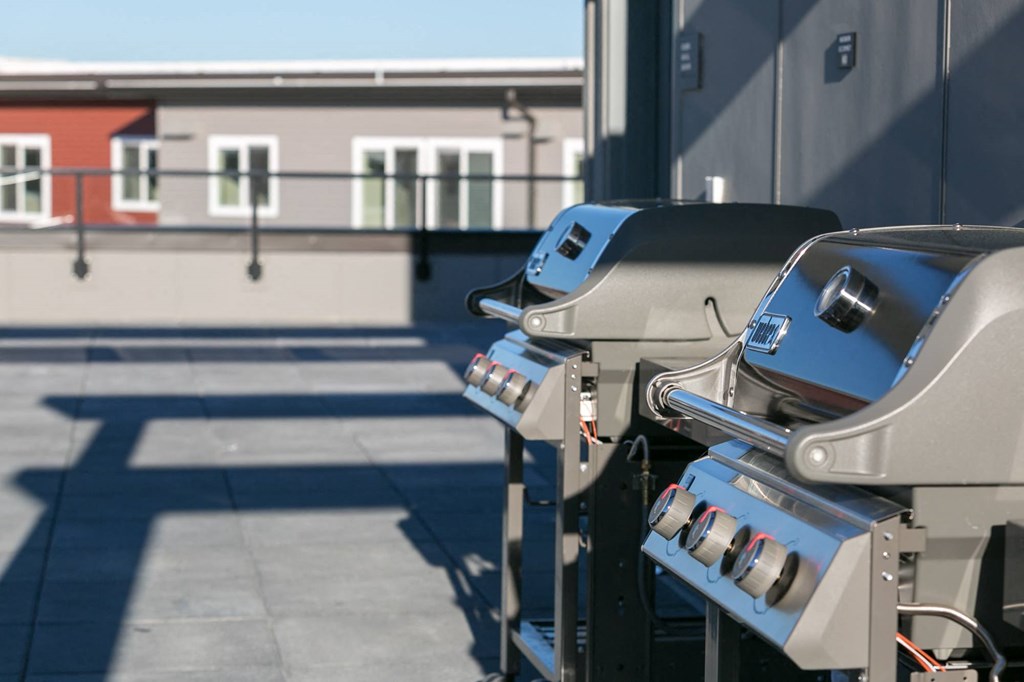 two bbq grills on the side of a building