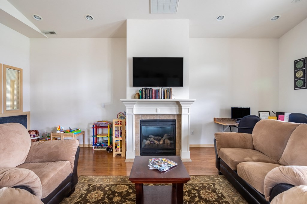 a living room with couches and a fireplace and a television
