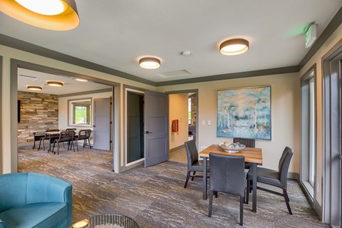 A dining room with a table set for four.