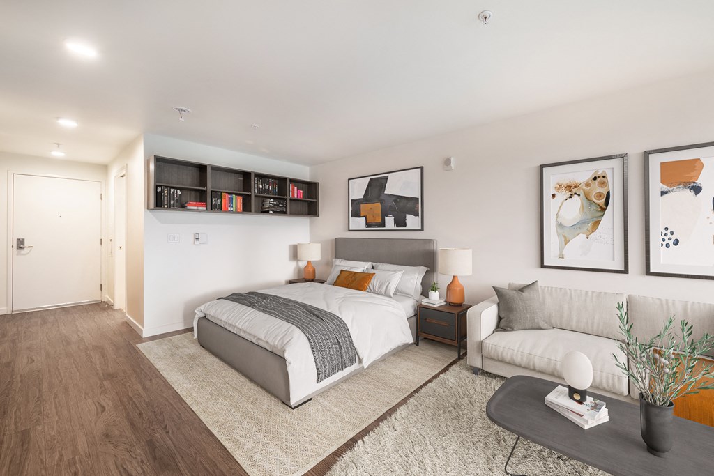 a bedroom with a bed and a couch