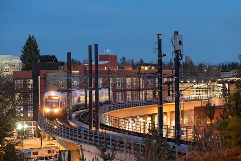 a train on a track in front of a building