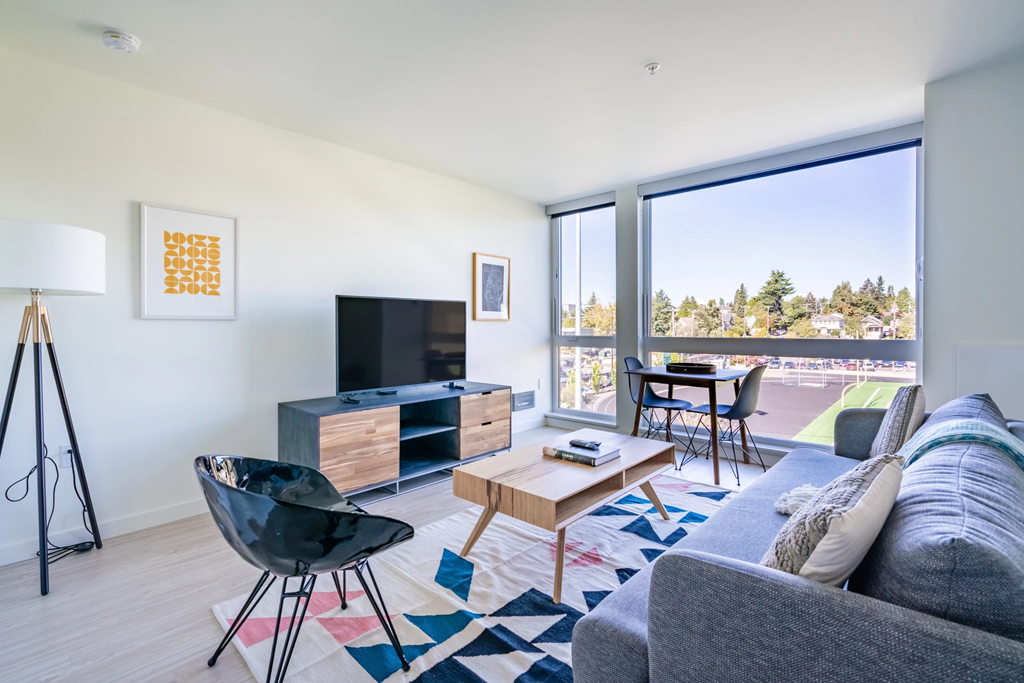 a living room with a couch and a chair and a television
