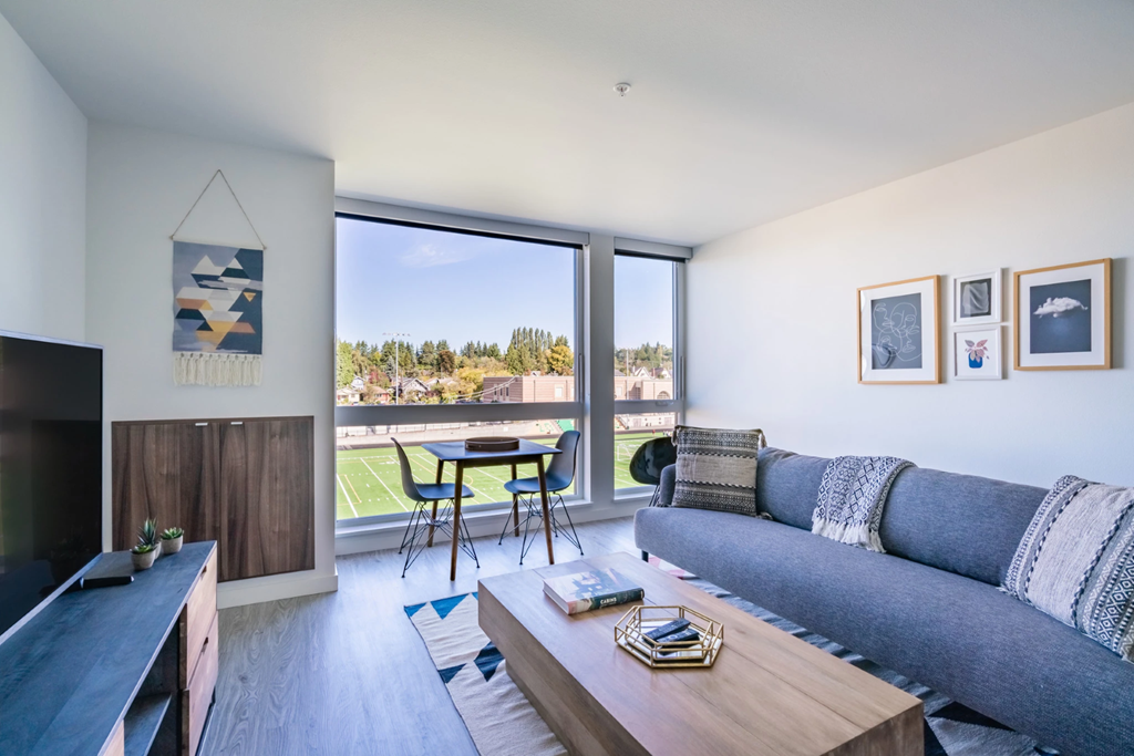 a living room with a couch and a table and a tv