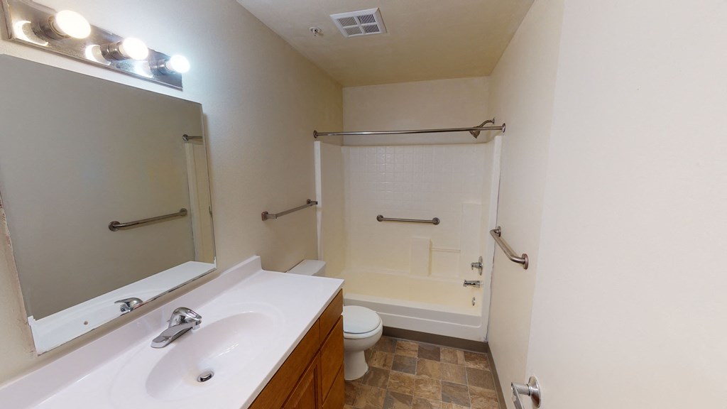a bathroom with a sink and a shower and a toilet