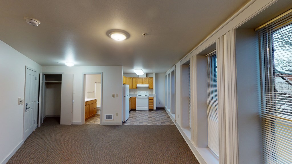 a hallway with a kitchen and a door to a bathroom