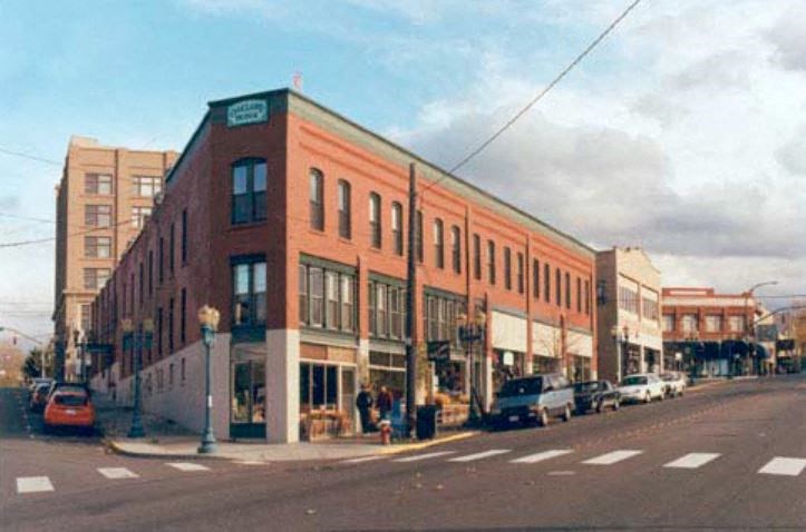 a large brick building on the corner of a street