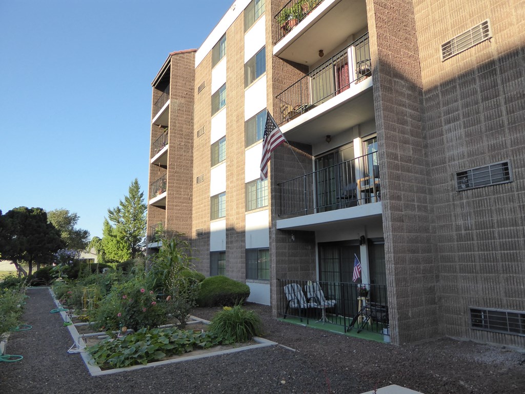 an apartment building with a courtyard and an flag