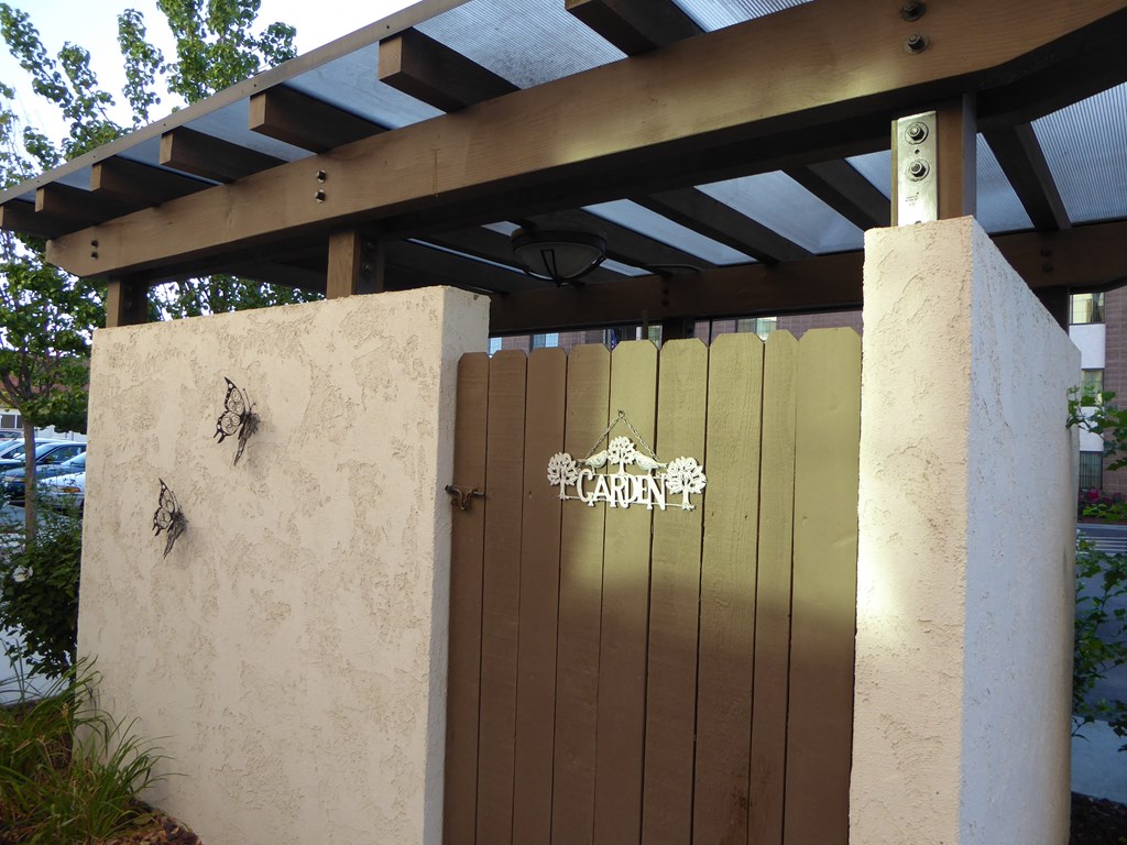 the gate to the gazebo has a sign on it that says garden